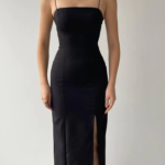 Black slit bodycon party wear midi dress for women with thin straps and elegant fit.