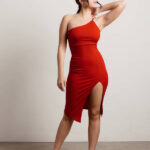 Woman in red one-shoulder bodycon dress with slit, styled for midi party wear dresses look